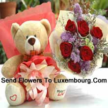 Bunch Of 7 Red Roses And A Medium Sized Cute Teddy Bear Delivered in Luxembourg