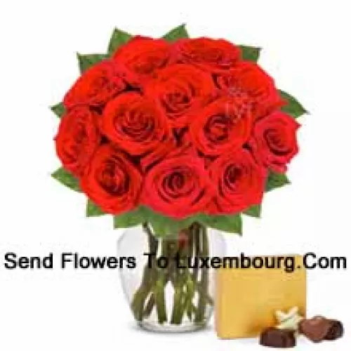 11 Red Roses With Some Ferns In A Glass Vase Accompanied With An Imported Box Of Chocolates
