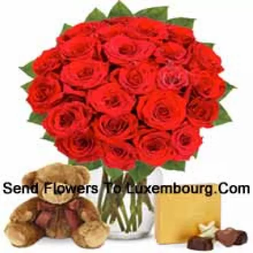25 Red Roses With Some Ferns In A Glass Vase Accompanied With An Imported Box Of Chocolates