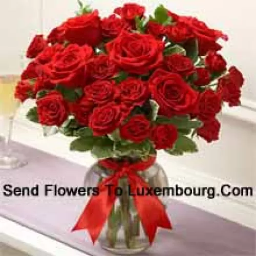 37 Red Roses With Some Ferns In A Glass Vase
