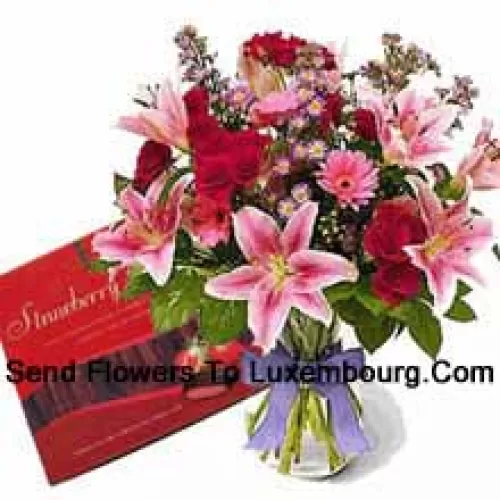 Assorted Flowers In A Vase And A Box Of Chocolate