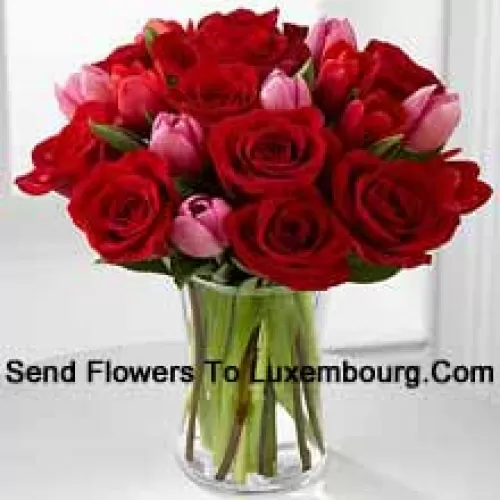 11 Red Roses And 6 Pink Tulips With Some Seasonal Fillers In A Glass Vase