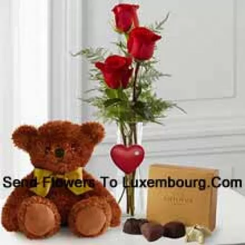 Three Red Roses With Some Ferns In A Vase, A Cute Brown 10 Inches Teddy Bear And A Box Of Godiva Chocolates. (We reserve the right to substitute the Godiva chocolates with chocolates of equal value in case of non-availability of the same. Limited Stock)